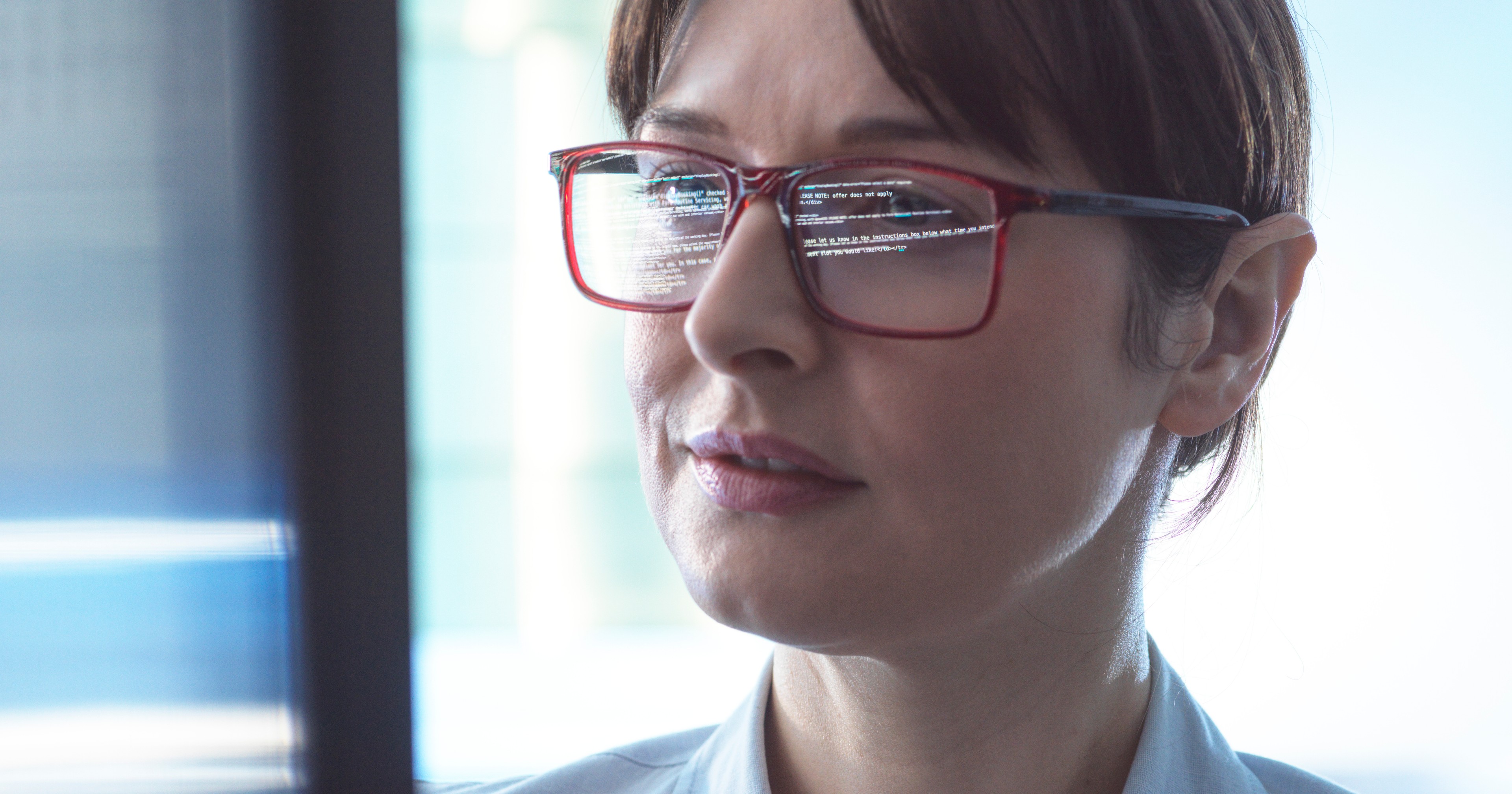 Female legal professional looking at legal ai for general counsel, ai for general counsel, legal ai